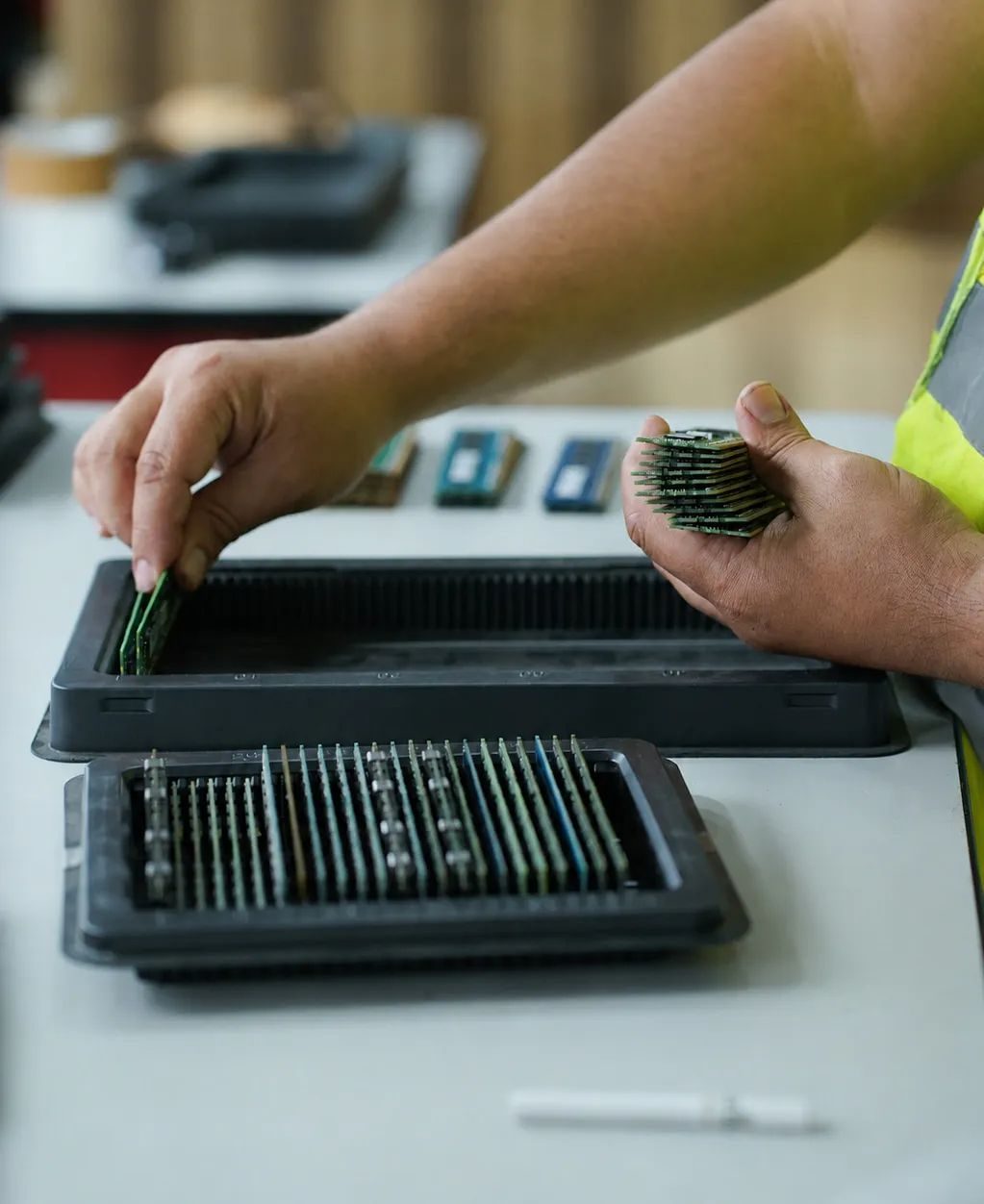 Memory modules being sorted into trays